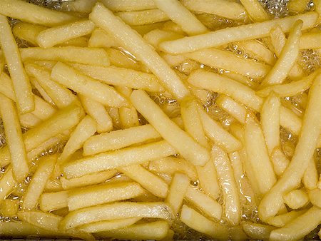 deep fry - Close-up of French fries cooking Stock Photo - Premium Royalty-Free, Code: 640-01363126