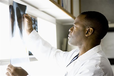 doctor looking at xray - Male doctor looking at chest x- rays Stock Photo - Premium Royalty-Free, Code: 640-01363145