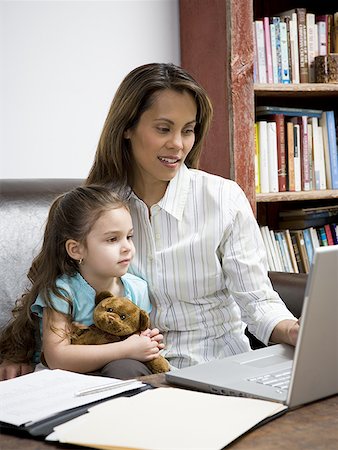 Mother and young daughter working on laptop computer Stock Photo - Premium Royalty-Free, Code: 640-01363205