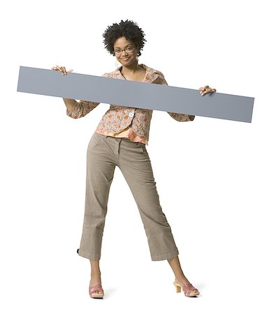 Portrait of a young woman holding a placard Stock Photo - Premium Royalty-Free, Code: 640-01363238