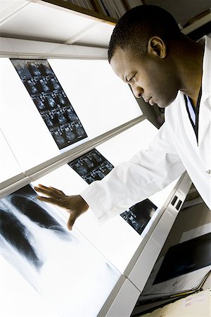 doctor looking at xray - Male doctor looking at chest x- rays Stock Photo - Premium Royalty-Free, Code: 640-01363261