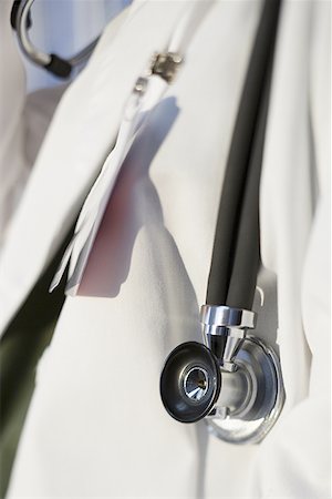 Mid section view of a doctor with a stethoscope Stock Photo - Premium Royalty-Free, Code: 640-01363305