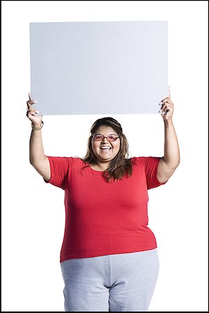 Heavyset young woman holding blank sign Stock Photo - Premium Royalty-Free, Code: 640-01363370