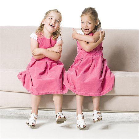 simsearch:640-01363386,k - Two girls sitting side by side on a couch Foto de stock - Sin royalties Premium, Código: 640-01363386