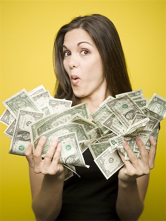 simsearch:640-01362961,k - Portrait of a young woman holding American dollar bills Stock Photo - Premium Royalty-Free, Code: 640-01363387