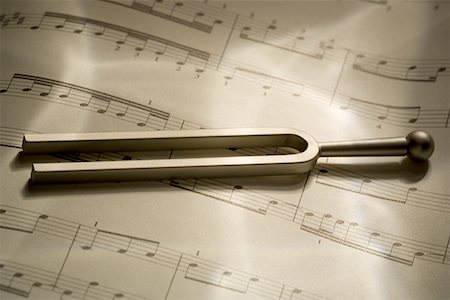 Close-up of a tuning fork and music sheets Stock Photo - Premium Royalty-Free, Code: 640-01363397