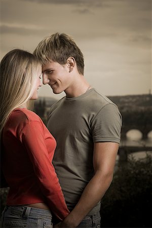 Profile of a young man looking at a young woman Stock Photo - Premium Royalty-Free, Code: 640-01363451