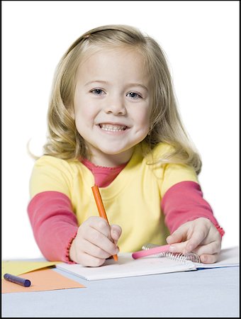 Portrait of a girl coloring with crayons Stock Photo - Premium Royalty-Free, Code: 640-01363526