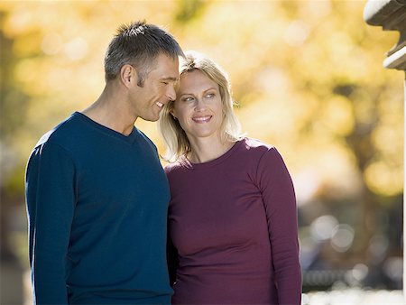 Couple standing side by side in a park Stock Photo - Premium Royalty-Free, Code: 640-01363587