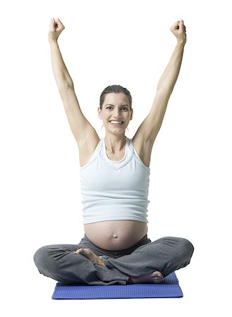 Portrait of a pregnant woman sitting on the floor stretching Stock Photo - Premium Royalty-Free, Code: 640-01363685