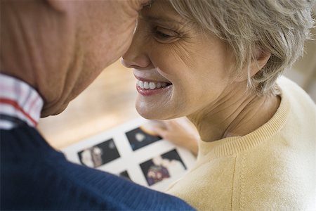 Close-up of an elderly couple smiling and touching heads Stock Photo - Premium Royalty-Free, Code: 640-01363690