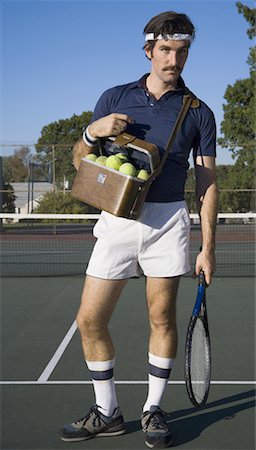 retro funny fashion pictures - Young man holding tennis balls and a tennis racket Stock Photo - Premium Royalty-Free, Code: 640-01363816