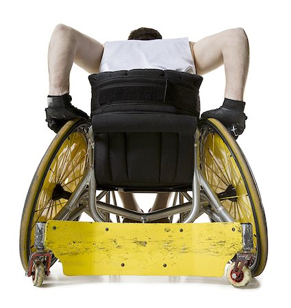 rear wheel - Rear view of a young man sitting in a wheelchair Stock Photo - Premium Royalty-Free, Code: 640-01363878