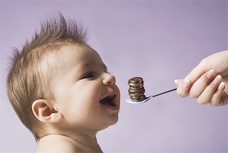 eat mouth closeup - Baby with spoon and stack of coins Stock Photo - Premium Royalty-Free, Code: 640-01363898