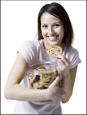 simsearch:640-01362854,k - Portrait of a young woman eating a cookie out of a jar of cookies Stock Photo - Premium Royalty-Free, Code: 640-01363956