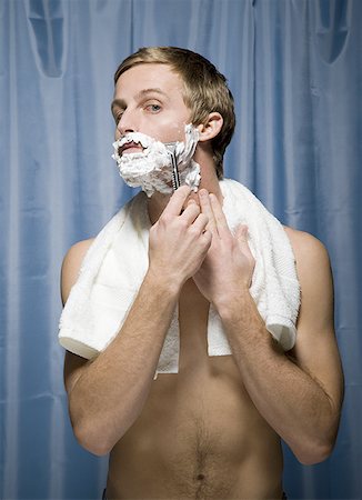 Close-up of a young man shaving Stock Photo - Premium Royalty-Free, Code: 640-01363953