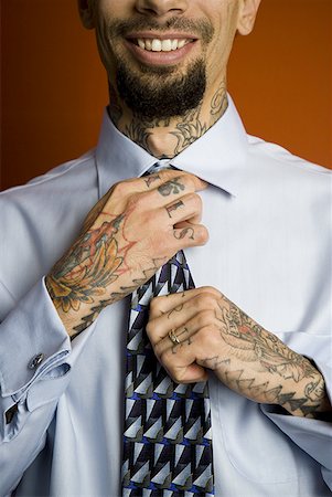 face man tatoo - Man with tattoos in shirt and tie smiling Stock Photo - Premium Royalty-Free, Code: 640-01363960