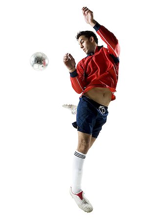 football man kicking white background - Man kicking soccer ball Stock Photo - Premium Royalty-Free, Code: 640-01458490