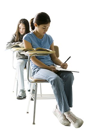 Two girls at school desks doing written work Stock Photo - Premium Royalty-Free, Code: 640-01458510