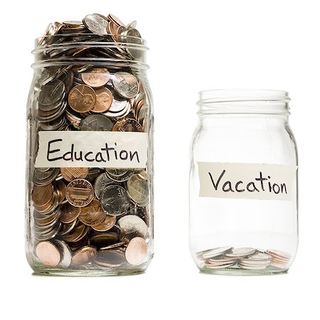 education saving - Two glass jars with change labeled Education and Vacation Stock Photo - Premium Royalty-Free, Code: 640-01458541