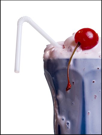 Close-up of melting milkshake with straw and maraschino cherry Stock Photo - Premium Royalty-Free, Code: 640-01458621