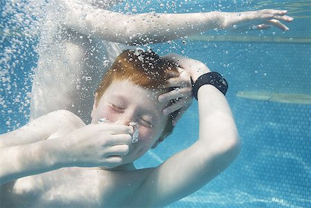 family underwater in a pool - Two boys swimming underwater Stock Photo - Premium Royalty-Free, Code: 640-01458637