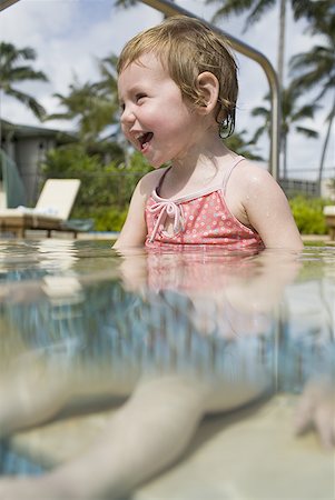 Girl sitting in outdoor pool smiling Stock Photo - Premium Royalty-Free, Code: 640-01458640