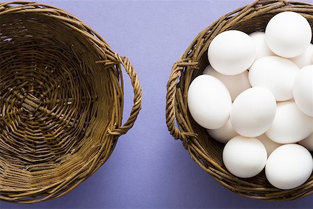 Empty basket and basket filled with eggs Stock Photo - Premium Royalty-Free, Code: 640-01458674