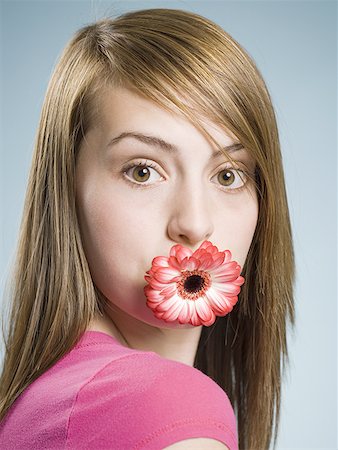 simsearch:640-02773811,k - Close-up of woman with flower in her mouth Stock Photo - Premium Royalty-Free, Code: 640-01458743