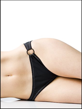 swimsuit model white background - Mid-section view of woman in bikini lying down Stock Photo - Premium Royalty-Free, Code: 640-01458785
