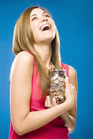 simsearch:640-02773597,k - Woman holding jar filled with coins smiling Foto de stock - Sin royalties Premium, Código: 640-01458856