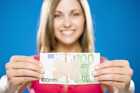 Woman with torn one hundred dollar euro banknote with plastic strips Foto de stock - Sin royalties Premium, Código: 640-01458884