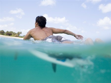 simsearch:640-02773714,k - Man lying on surfboard in water Fotografie stock - Premium Royalty-Free, Codice: 640-01458963