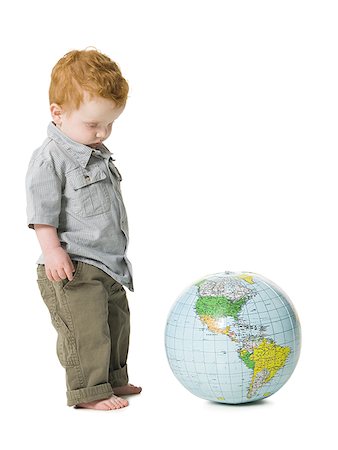 simsearch:640-01459060,k - Young boy standing beside globe Foto de stock - Sin royalties Premium, Código: 640-01459073