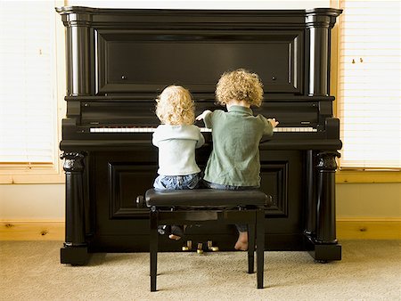 simsearch:640-03258191,k - Rear view of two children sitting at upright piano Foto de stock - Sin royalties Premium, Código: 640-01459088