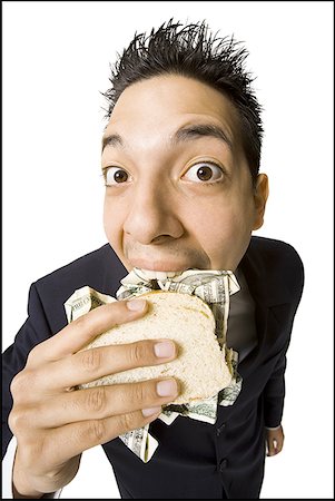 simsearch:640-03265364,k - Young businessman eating money sandwich Stock Photo - Premium Royalty-Free, Code: 640-01459094