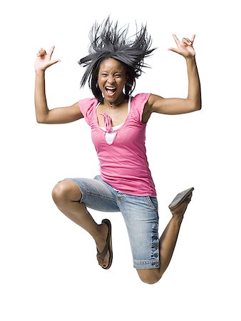 Woman leaping and smiling with hands up Stock Photo - Premium Royalty-Free, Code: 640-01574821