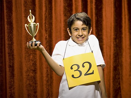simsearch:640-02774365,k - Boy contestant holding trophy Stock Photo - Premium Royalty-Free, Code: 640-01575003