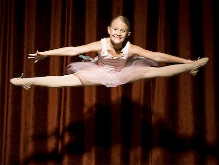 simsearch:640-02774467,k - Ballerina girl on stage leaping and smiling Stock Photo - Premium Royalty-Free, Code: 640-01575013