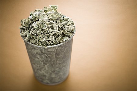 Waste paper basket with crumpled money Stock Photo - Premium Royalty-Free, Code: 640-01575046