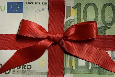 One hundred Euro banknote with red ribbon closeup Stock Photo - Premium Royalty-Free, Code: 640-01575062