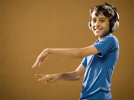 simsearch:640-02775245,k - Boy with headphones smiling and waving hands Stock Photo - Premium Royalty-Free, Code: 640-01575111