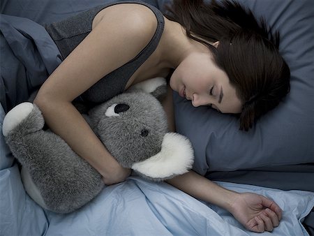 simsearch:640-02774723,k - Woman sleeping in bed with stuffed animal Foto de stock - Sin royalties Premium, Código: 640-01575211