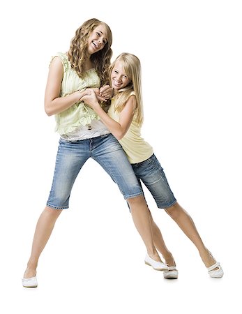 sisters fighting - Deux filles jouent au combat et souriant Photographie de stock - Premium Libres de Droits, Code: 640-01601334