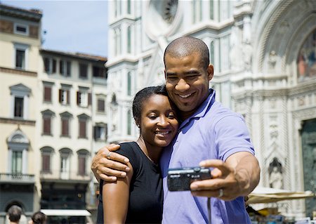 Couple hugging and taking self portrait with camera Stock Photo - Premium Royalty-Free, Code: 640-01601559