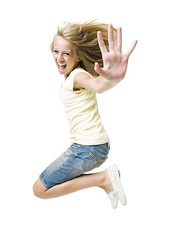 Girl smiling and leaping with hand up Stock Photo - Premium Royalty-Free, Code: 640-01601671