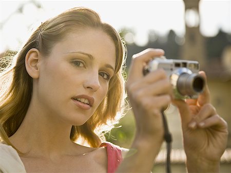 simsearch:640-01601608,k - Woman taking a photograph outdoors Stock Photo - Premium Royalty-Free, Code: 640-01601744