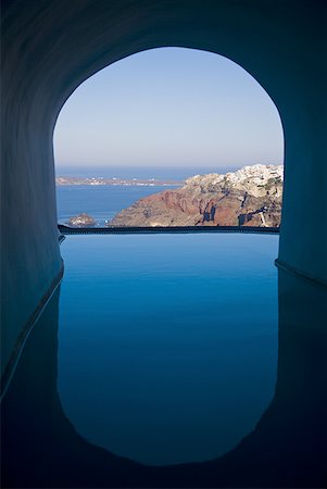 pools interior exterior - View of infinity pool through archway with mountains and water Stock Photo - Premium Royalty-Free, Code: 640-01601740