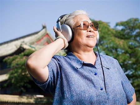 simsearch:640-02775245,k - Mature woman outdoors with headphones smiling Stock Photo - Premium Royalty-Free, Code: 640-01645469