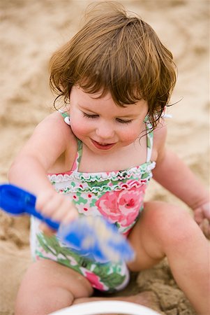 simsearch:640-03259235,k - Girl on sandy beach with toy shovel Stock Photo - Premium Royalty-Free, Code: 640-01645839